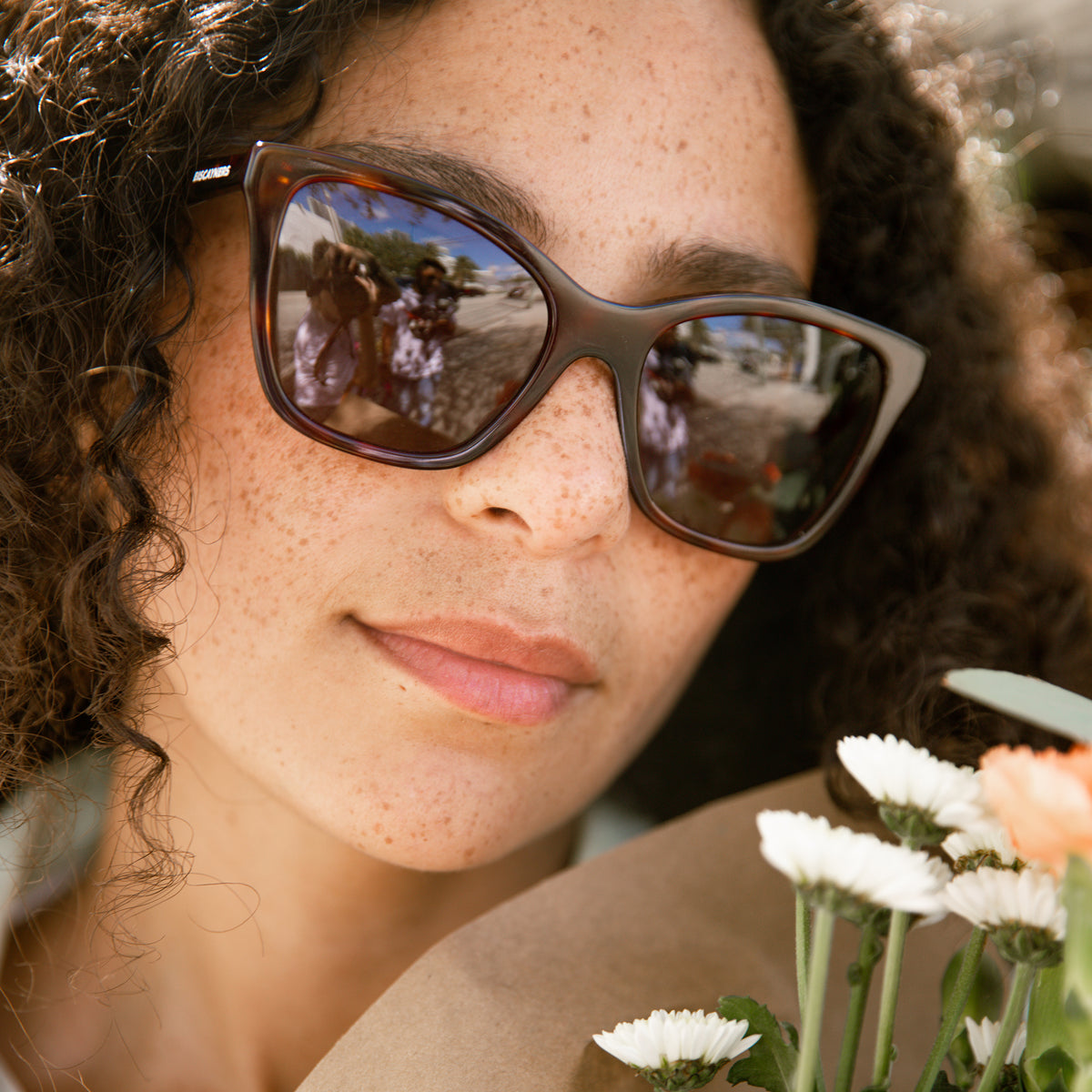 woman with tortoise sunglasses